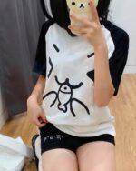 Woman wearing Cute Cotton Black Shorts - kaomoji aesthetic shorts with a black and white graphic print.