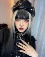 Vegan leather studded beret with silver studs on a model's head.