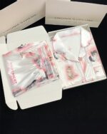 Kitty silky pajamas in a box, featuring illustrations of cute cats. Kawaii clothing design.