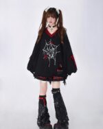Black loose gothic sweater with spider web and heart graphic details. It features a relaxed fit and distressed sleeves.