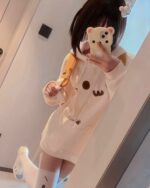 A white kaomoji bear hoodie featuring bear graphics on a casual sweatshirt.