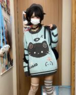 Mint neko sweater featuring a cat face design, worn by a person.