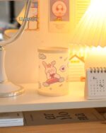 Kawaii pen holder featuring cute animal illustrations on a light yellow surface, measuring 11.3x8cm.
