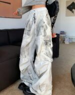 White washed denim y2k artsy pants with a large print design and multiple pockets.