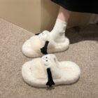 Fluffy Hand holding Slippers word2
