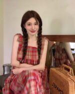 Model wearing a red and white french vintage suspender skirt, with a gathered skirt and spaghetti straps.