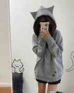 Gray cat paw hoodie with hood and paw print details. Kawaii cat paw hoodie.