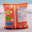 Orange plushie shaped like a Cheesy Puffs bag, with instructions to open, squeeze, and eat.