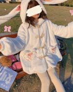 Fluffy rabbit ears hoodie worn by a person outdoors.