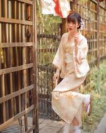 Woman wearing a Hanabi Pattern Summer Yukata dressing in an outdoor setting.