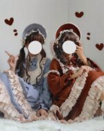 Two models wearing classic lolita dresses with ruffles and matching hats. The dresses feature bows and frills.