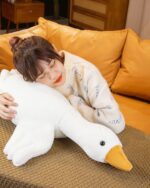 Feather Gang - The Giant Goose Plush, a large, plush goose toy held by a person.
