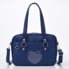 Navy blue japanese schoolbag featuring a heart-shaped window and multiple compartments.