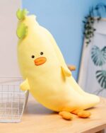 Cute kawaii food plushie, a yellow zucchini plush with orange feet and a green stem.