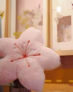 Pink cherry blossom pillow, soft plush decoration, kawaii decor style.