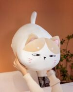Kawaii chonky cat plushie – soft, fluffy pillow toy with a cute face and pink accents.