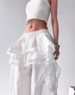 White y2k cargo pants with lace trim and a ruffled detail.