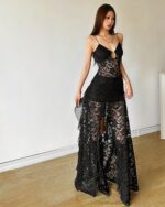 Black gothic aesthetic dress with lace detailing and a cutout design. Transparent and long-sleeved.