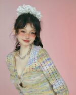 Hollow-out knitted long-sleeved sweater in vintage aesthetic, featuring a pastel color palette.