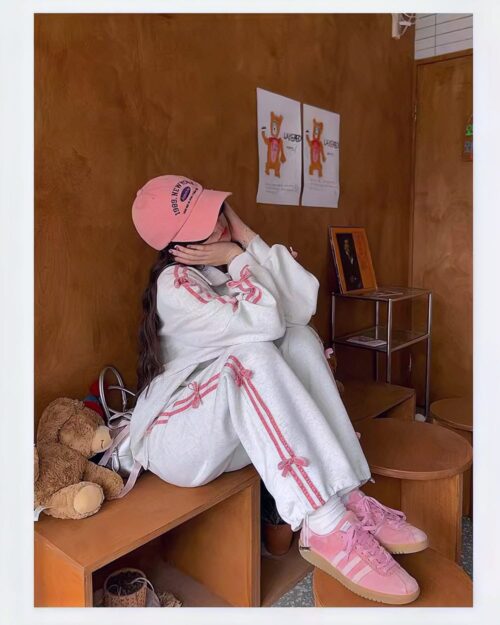 Young woman wearing a korean aesthetic set, including a sports sweater and Adidas sneakers.