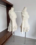 Two views of a cream-colored bow knitted set on mannequins, featuring ruffled skirts.