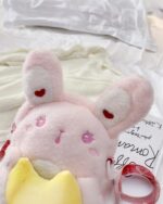 Pink chibi loli handbag with heart embellishments and a ribbon.