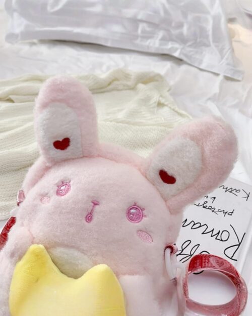 Pink chibi loli handbag with heart embellishments and a ribbon.