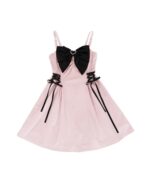 Pink kawaii goth dress with a black bow, lace-up details, and spaghetti straps.