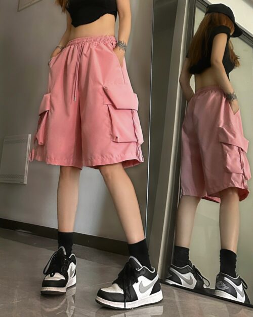 Pink loose casual shorts with cargo pockets, showcasing a korean aesthetic style.