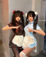 Two women posing in a maid hanfu dress, featuring traditional Chinese and Western elements.