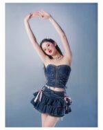 Model wearing a high waist french style bow skirt - Y2K Aesthetic, denim corset and ruffle details.