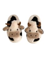 Pair of cow slippers featuring black and white plush design with cow details.