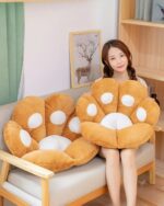 Kawaii Neko Paw Cushion in brown, plush material. Cute animal pillow decoration.