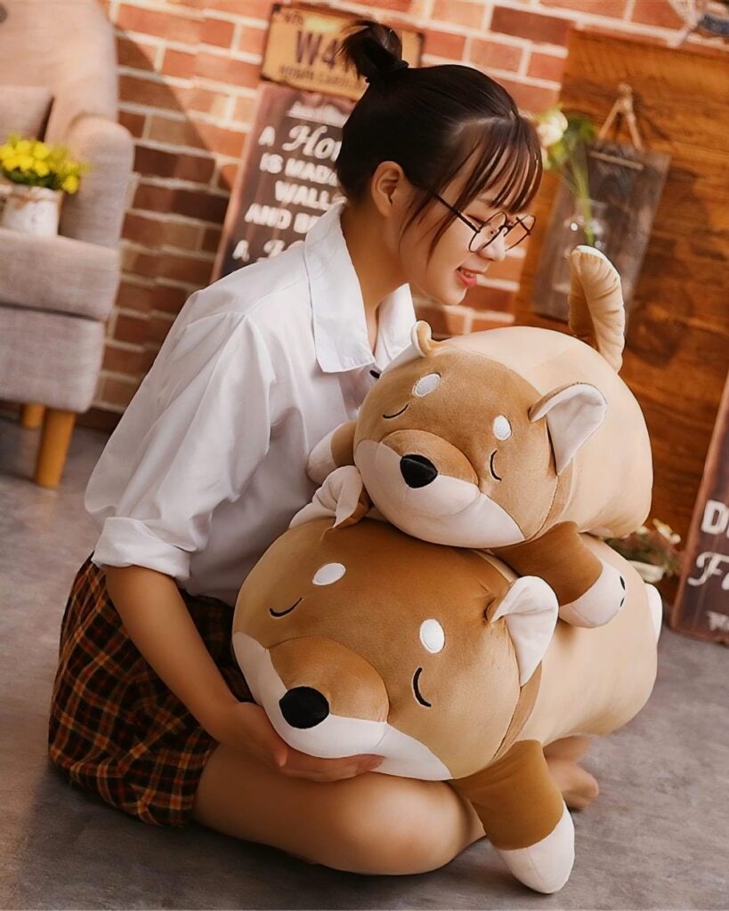 Kawaii lazy shiba plushie hugging a large, brown stuffed dog.