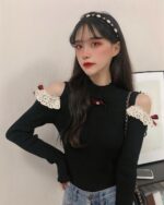 Black coquette aesthetic top with lace sleeves and bow detail.