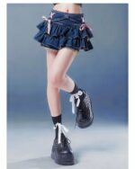 Dark wash denim french style bow skirt featuring a layered ruffle design and pink bow accents.