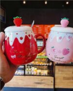 Two strawberry ceramic mugs with fruit designs, featuring "Sweet Strawberry" and "Pure Strawberry".