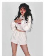 Model wearing a white kawaii fluffy pajamas set, featuring a cropped hoodie and shorts.