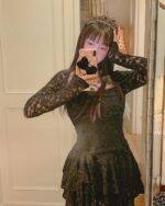 Black lace gothic aesthetic dress worn by a model, featuring long sleeves and a fitted silhouette.