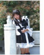 A young woman wearing a classic maid outfit, black and white lace details, kawaii clothing.