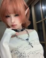 Close-up of a thin long sleeve top with a musical print design.