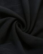 Close-up of black fabric for the Korean aesthetic dress, showing texture and pleats.