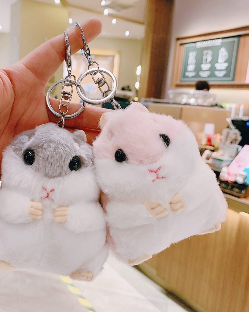 Close-up of two kawaii chibi hamster plushies, adorable keychain toys.