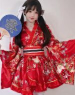 Woman wearing a red kawaii short yukata with floral details, perfect for summer festivals.