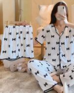 White and black korean aesthetic pajamas set with bow print, including shorts and top.