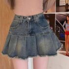 Blue denim y2k aesthetic skirt with pleats and frayed edges.