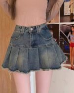 Blue denim y2k aesthetic skirt with pleats and frayed edges.