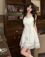 Lolita white laced dress featuring delicate lace and a ruffled design, worn by a model.