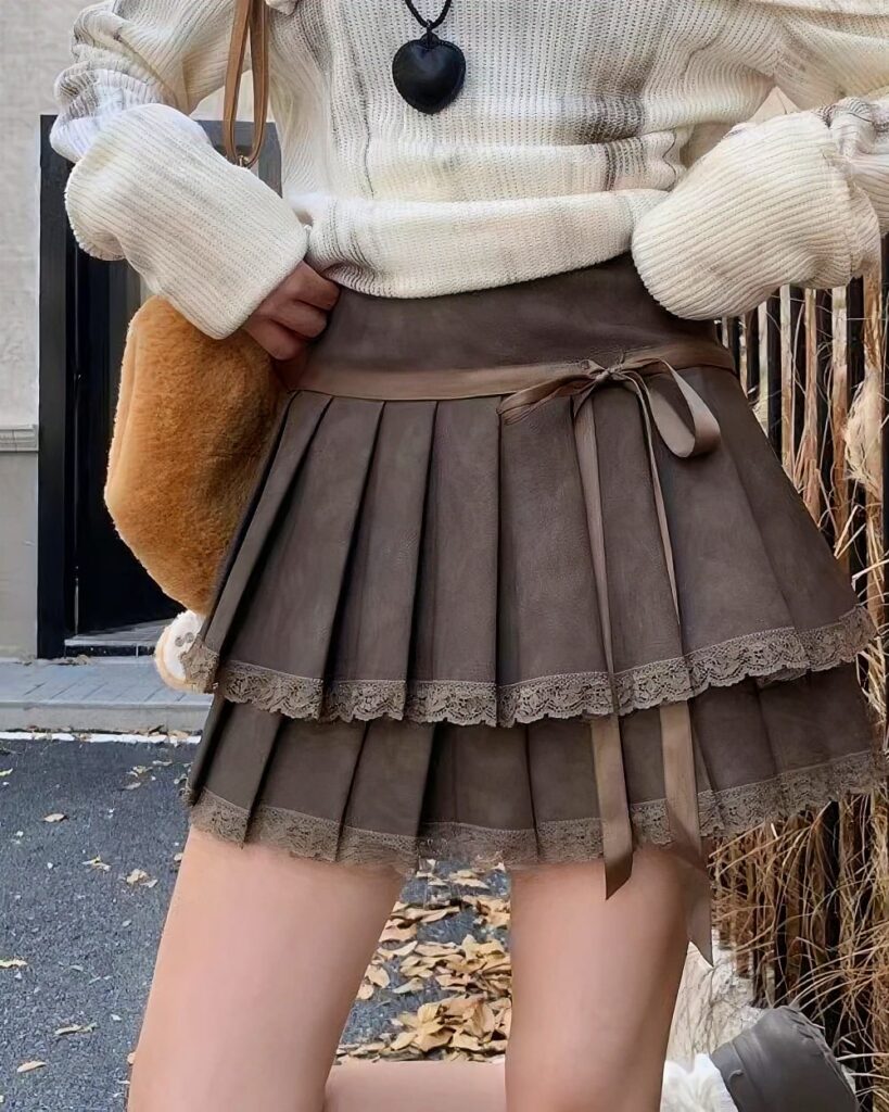 Brown laced pleated korean aesthetic skirt with lace trim and bow closure.