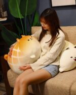 A Kawaii melonwan plushie resting in a woman's arms.
